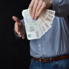 59213-01-rychla-pujcka-a-pristup-businessman-blue-shirt-holding-czech-republic-cash-banknotes-his-hand-309845970.jpg